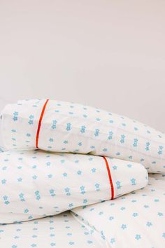 three pillows stacked on top of each other with snowflakes printed on the covers