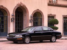 a black car parked in front of a building