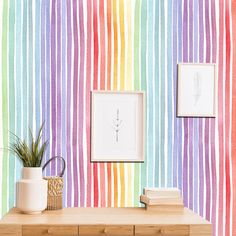 there is a colorful wallpaper with stripes on it and a plant in the corner