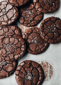 chocolate cookies with powdered sugar on top and the words butters written in red