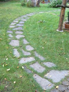 a stone path is shown in the grass