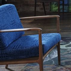 a blue chair sitting on top of a wooden floor