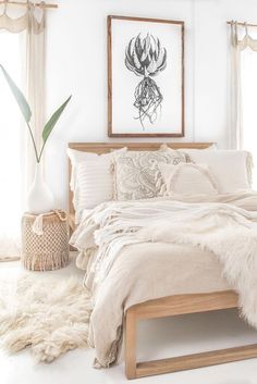 a bedroom with a bed, rugs and pictures hanging on the wall above it