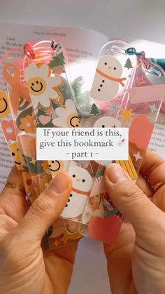 someone holding up some cute little bookmarks