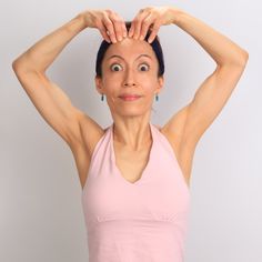 a woman with her hands on her head