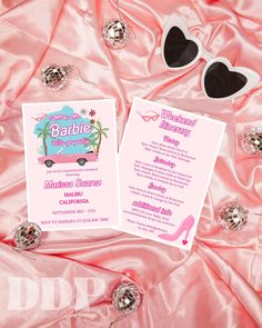 the bachelor party is set up on pink satin with sunglasses and cards for guests to use