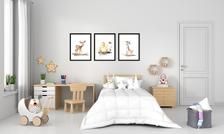 a bedroom with white walls and two pictures on the wall above the bed, along with toys