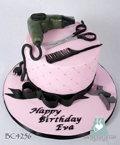 a pink birthday cake with scissors and hairdryer on it's top is shown