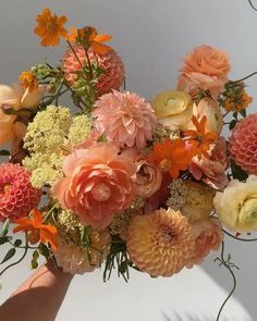 a person holding a bouquet of flowers in their hand