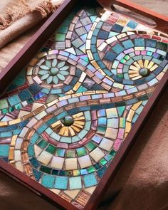 a wooden tray with a mosaic design on it