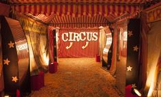 the circus tent is decorated with red and white striped walls, stars on the ceiling