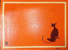 an orange background with a black cat sitting on it's hind legs and tail