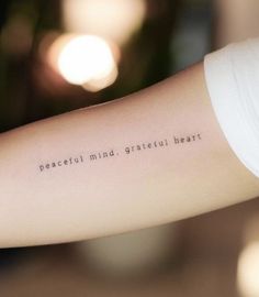 a woman's arm with the words peaceful mind, grateful heart on her left arm