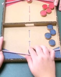 two hands are playing an interactive board game