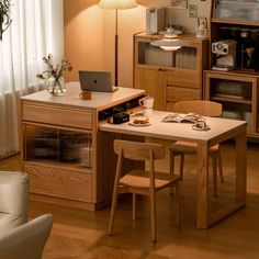 a laptop computer sitting on top of a wooden table in a living room next to a window