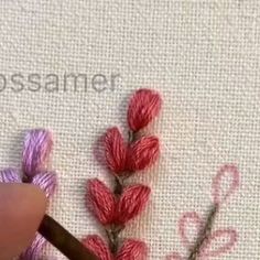 the needle is being used to stitch flowers