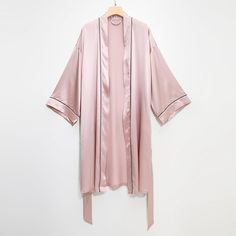 A set of pure luxury. Pair our Pasithea kimono silk robe with our knee-length River Nymph slip dress. Enjoy the cool and gentle touch of silk at every moment of your life. Designed in Toronto.  Material . 100% mulberry silk . 22 momme silk charmeuse  Benefit of Silk . Durable: Withstands machine washing, built to last . Drape: Falls into folds, flows like liquid . Dense: Wrinkles smooth out quickly . Cooling: Moisture wicking, stay fresh even in humidity . Eco-friendly: Silk is 100% biodegradabl 30’s Fashion, Pink Silk Robe, Pink Kimono, Place Dress, Black Kimono, Satin Bags, Slip Dresses, Women Rising, Silk Robe