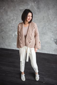 This beige oversize chunky knit short cardigan is made of soft, cozy and fluffy yarn. Wearing this handmade knitted sweater you will be very stylish. Chunky cardigan will keep you feel warm in any cold weather. DETAILS: Size: comes in S, M and L. Color: Beige (on the picture) and also you can choose from more colors options as well Length: 24" (60 cm) Materials: 60% wool, 40% acrylic Model is 5'5" (170 cm) and wears size S. Please note that there might be some colors discrepancies due to the dif Chunky Knit Beige Knitting Pattern, Fluffy Yarn, Chunky Cable Knit Sweater, Solid Beige, Chunky Cable Knit, Pullover Outfit, Short Cardigan, Chunky Cardigan, Sweater For Women