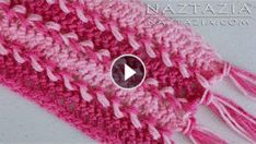 a crocheted pink and white scarf with tassels