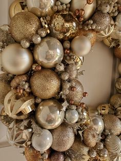 a christmas wreath with ornaments hanging from it