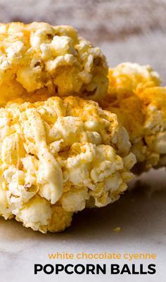 popcorn balls are stacked on top of each other with the words white chocolate cyclone popcorn balls