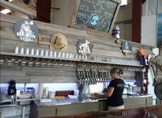 a woman behind the bar at a restaurant