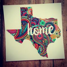 a piece of paper with the word home written on it in bright colors and paisley designs