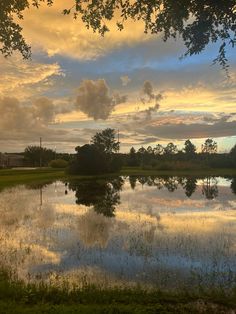 the sky is reflecting in the water at sunset