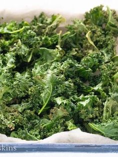 a bowl filled with green vegetables on top of a table