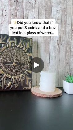 a wooden table topped with a cake next to a potted plant and a plaque that says did you know that if you put coins and a bay leaf in a glass of water?