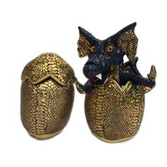 two gold and black figurines sitting on top of each other