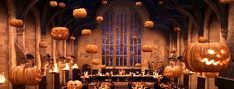 a large room filled with lots of pumpkins on the ceiling and decorations hanging from the ceiling