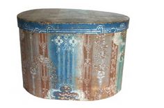 an old round wooden box with decorative designs on the top and sides, painted in blue, red, orange and white