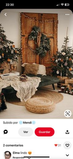 a room with christmas trees and decorations on the wall next to a bed in front of a wooden door