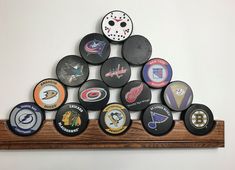 a wooden shelf with hockey pucks on it and a wall hanging in the background