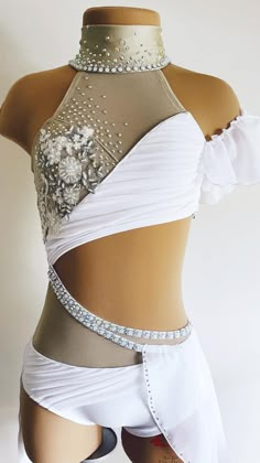 a woman's white belly dance costume with silver and crystal beads on the top