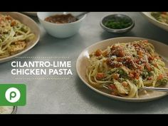 a table topped with plates of pasta and sauce