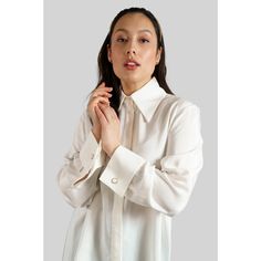 Introducing the Femponiq Ivory Long Sleeve Shirt, a perfect blend of style and versatility. Crafted in London from lightweight viscose rayon, this shirt offers a luxurious feel and polished look with the glossy surface and can be styled with tailoring, jeans or skirts. Featuring a relaxed shape with a gathered back detail, neat collar, double French cuffs adorned with two buttons, concealed button fastening through front and hip length. Finished with internal French seams. Composition: Cotton 100% Viscose Rayon  Care: Professional Dry Clean Only Made in: London, United Kingdom Tailoring Jeans, French Cuff Shirts, Back Shirt, French Cuff, Power Dressing, Viscose Rayon, French Seam, Independent Designers Fashion, Natural Fabrics