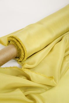 a person is holding the end of a yellow cloth