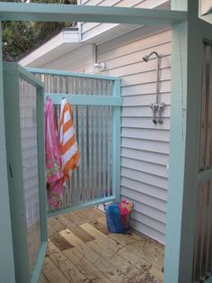 an outdoor shower in the corner of a house