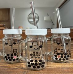 three mason jars with polka dot lids and straws in them on a counter top