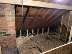 an attic with exposed walls and wood flooring in the process of remodeling