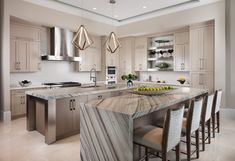 a large kitchen with marble counter tops and stainless steel appliances