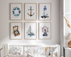 a baby's room with four pictures on the wall and a crib next to it