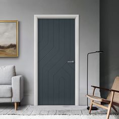 a living room with grey walls and white rugs, a gray door and chair