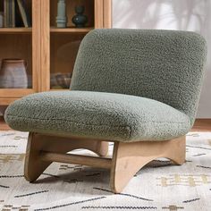 a green chair sitting on top of a rug