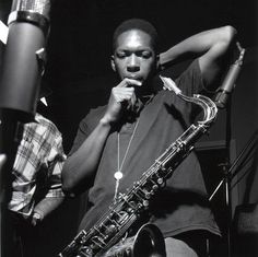 a man holding a saxophone in his right hand