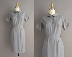 "Adorable classic vintage 1950s dress by Lanz. This vintage dress is in a wonderful gray color with a very flattering fitted bodice with bust darts, nipped waist, ad a lovely pencil skirt fit. Side metal zipper for closure. ✂------ M E A S U R E M E N T S ------- Best Fit: XS Bust: 32/32.5\" Waist: 24\" Hips: 34\" Shoulders: undefined Sleeves: 8\" Total Length: 38\" Tag/Label: Lanz Material: cotton Condition: Excellent vintage condition. Ready to wear. ☆ Layaway is available for this item! ☆ Exp 1950s Style Fitted Vintage Dress With Short Sleeves, Vintage Fitted Gray Dresses, Fitted Vintage Gray Dress, 1950s Vintage Dress With Buttons For Daywear, 1950s Shelf Bust Dress, 1950s Shirt Waist Dress, Vintage Fitted Collared Dress, 1950s Style, Unique Vintage Dresses, Shirt Dress Summer