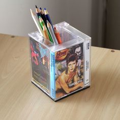 two pencils in a clear box on a wooden table