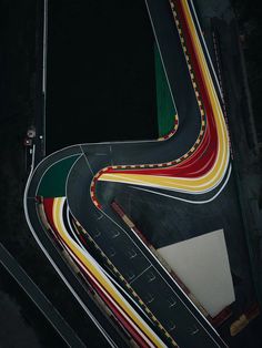 an aerial view of a winding road in the dark